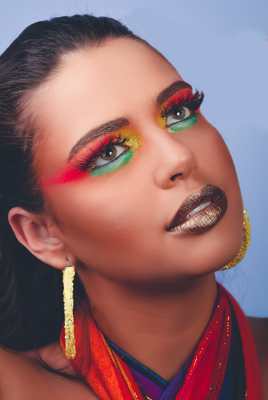woman with green eyes wearing gold earrings